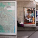 advertisement, billboard, outside, poster, train station, gray train, billboard, billboard, billboard, billboard, billboard, poster